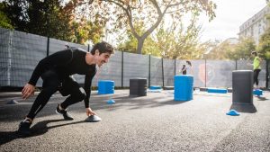 Fitness enthusiasts doing outdoor exercise in a city park, Boulogne-Billancourt, France.